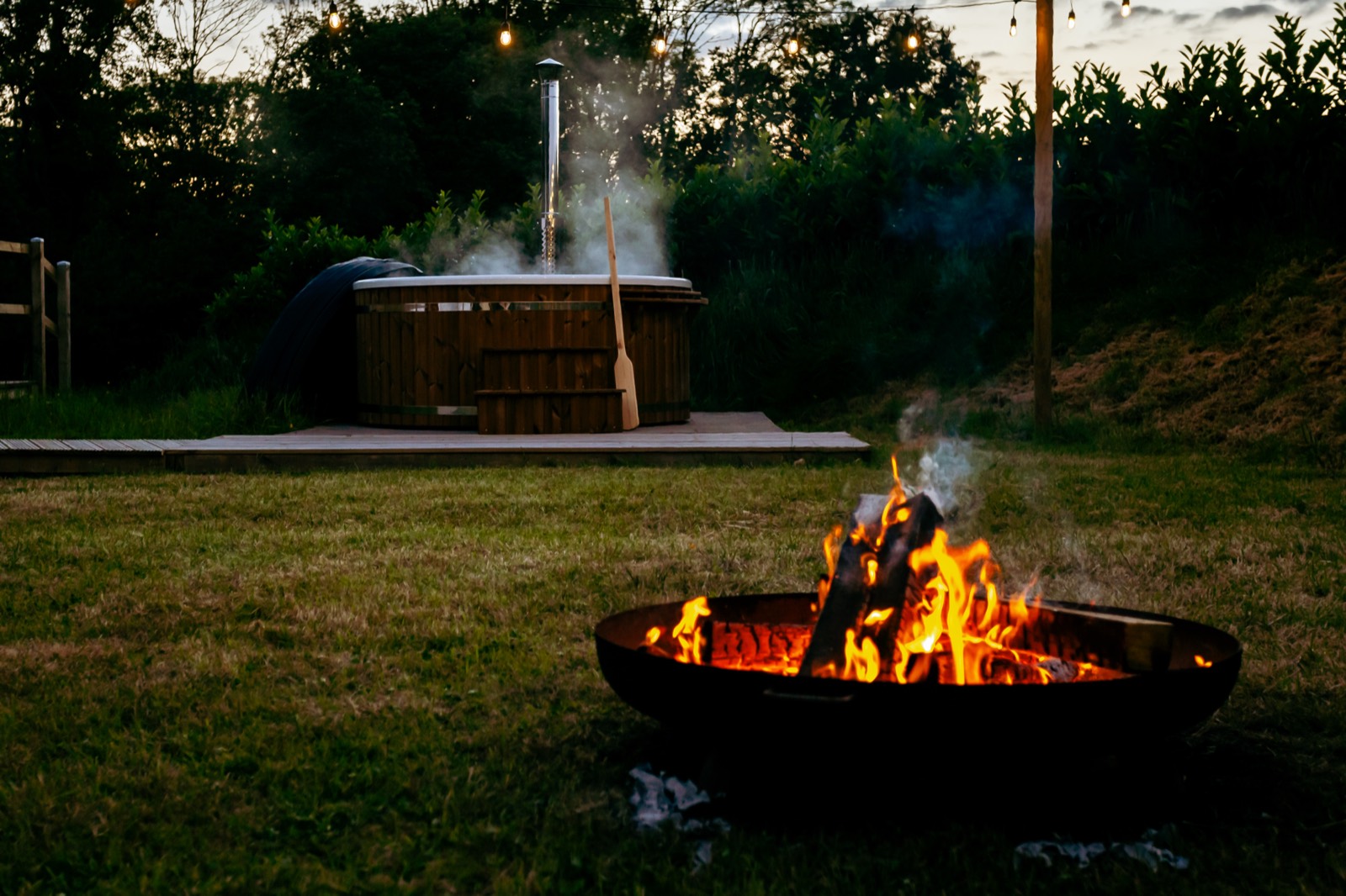 A woodfired hot tub at dusk